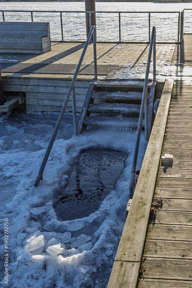 Fototapeta premium Denmark - Steps lead down to an opening in the ice for winter swimming.
