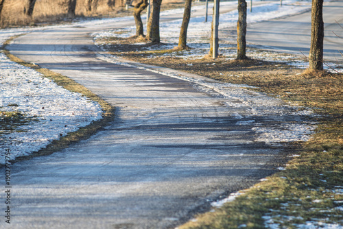 Wallpaper Mural Denmark - A winding paved path curves through a winter landscape with patches of snow and bare trees. Torontodigital.ca