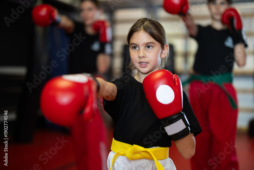 Photos Girl in red boxing gloves at boxing and self-defense training