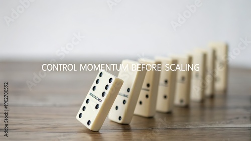 Controlled domino chain reaction midway through falling on a wooden surface