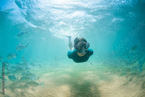 Female snorkeler swimming with tropical fish, Hikkaduwa, Sri Lanka