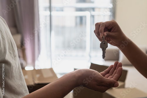 Handing over house keys for new home ownership achievement