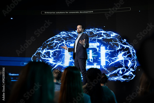 Photos Business manager hosting artificial intelligence presentation during convention event in auditorium, takes the stage for AI systems sales pitch