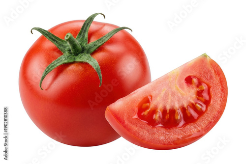Whole ripe red tomato and a freshly cut wedge showing the juicy interior on a deeply shaded field