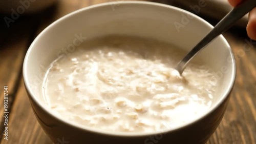 Bowl of Creamy Oatmeal with Spoon.