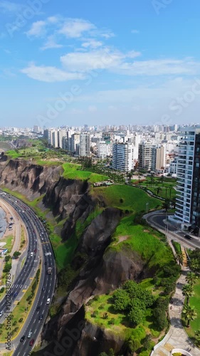 Aerial view of Lima's coastline, showcasing modern architecture and lush green spaces