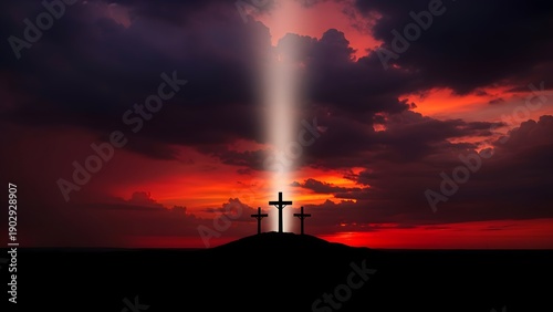 Silhouette of three crosses on a hill against a dramatic red sunset sky with a beam of light on the central cross