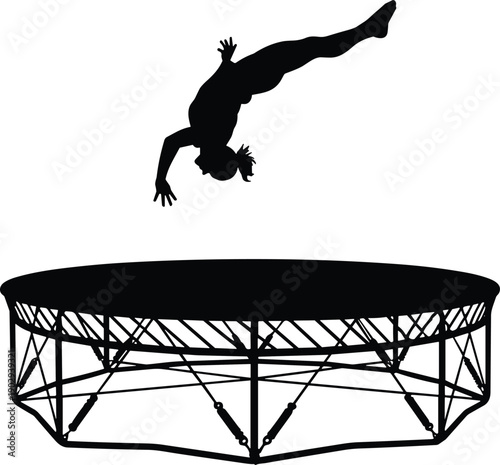 Black silhouette of a gymnast athlete jumping high on a trampoline performing an acrobatic flip in the air.