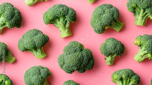 Fresh Broccoli Florets Pattern Repeating On Vibrant Pink Background  