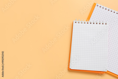 Blank notebooks on orange b...