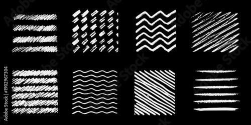 Collection of various white chalk like scribbles and line patterns on black