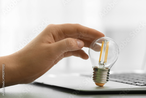 Female hand with laptop and...