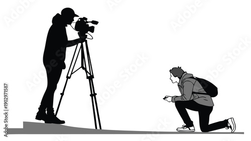 Cameraman filming subject kneeling down with a professional video camera setup