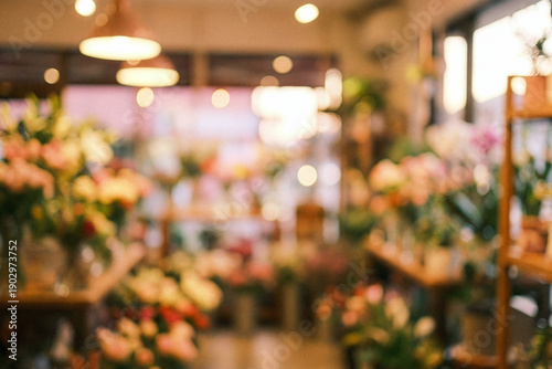 Blurred flower shop interior with colorful bouquets and warm lighting.