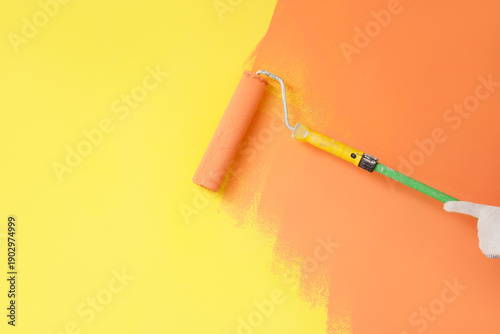 Male hand with roller paint...