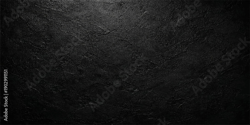 A dark grunge texture featuring a rough black and white stone pattern creates an old vintage concrete wall backdrop with a dirty grey surface design