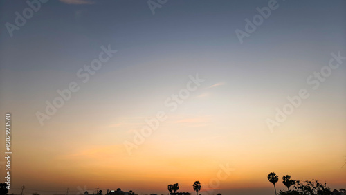 Photos Twilight gradient sky deepening above distant trees and calm rural land