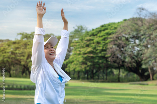Photography Middle-aged Asian woman exercises outdoors in a park