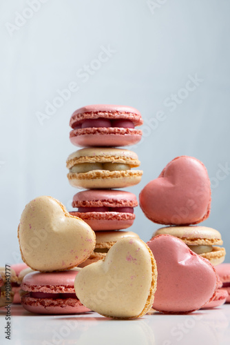 Bild auf Leinwand Colorful Heart-Shaped and Round Macaron Cookies Piled up in a Creative Display