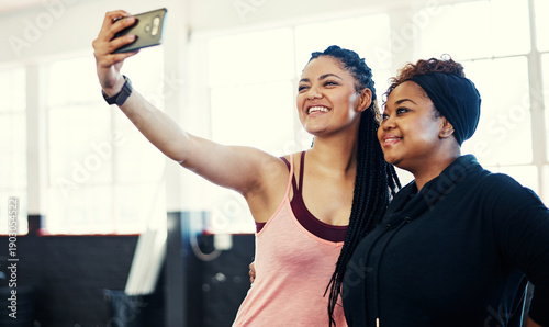 Fotografi Women, friends and happy for selfie at gym with memory, bonding and break at wellness center