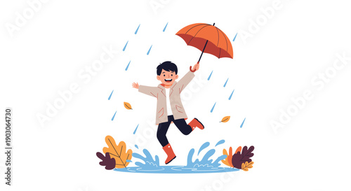 Happy young boy wearing a beige raincoat jumps into a water puddle with an umbrella while autumn leaves fall down.