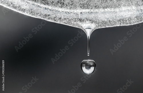 A drop of water is falling from a surface