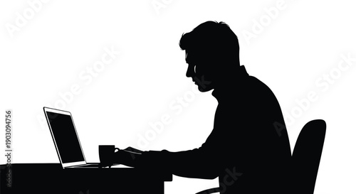 Silhouette of a focused professional working diligently on a laptop computer while sitting at a desk