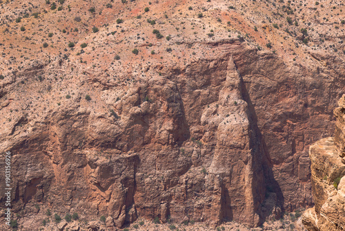 Photos Close-up view of rugged rocky canyon cliff with layered stone formations and spa