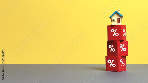 Cuadro en lienzo Miniature house on stack of red blocks with percentage signs representing mortga