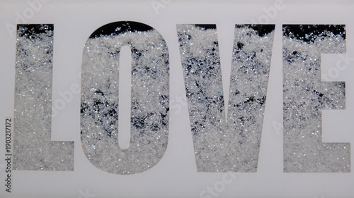 a set of decorative letters for the wall or mirror in the shape of LOVE featuring a diamond pattern made of crushed crystal or glitter