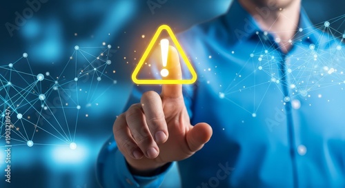 Man in blue shirt interacts with glowing yellow warning sign on finger tip with digital network background
