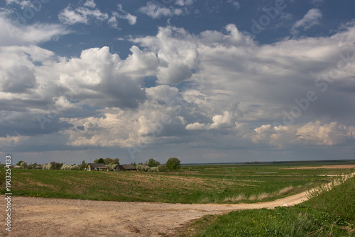 Rural landscape with fields and dramatic cumulus clouds