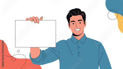 Cheerful young man dressed in a blue polo shirt holds up a blank white sign board for custom text or advertisement against abstract shapes.