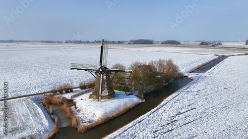 Historic European polder windmill in rural landscape