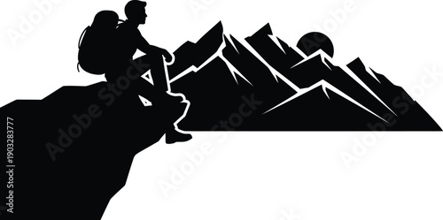 Hiker sitting on a rock formation and looking at the sunrise over a mountain range. 