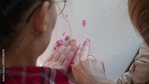 mother hugging a toddler. adult holding the child from behind. holiday home setting with soft natural light.
