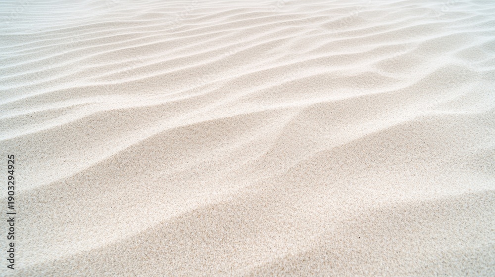 Fototapeta premium A close-up view of a sandy beach, showcasing the intricate patterns formed by the undulating grains of sand.