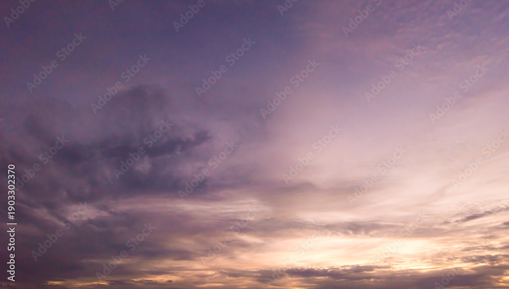 Fototapeta premium Panoramic view of sunset golden and blue sky nature background. Colorful dramatic sky with cloud at sunset.Sky background.Sky with clouds at sunset.