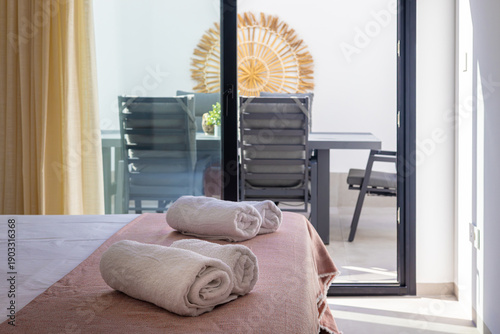 Bright Bedroom With Fresh Towels And Terrace View