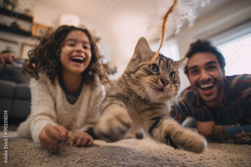 Happy Family Playing With Tabby Cat At Home