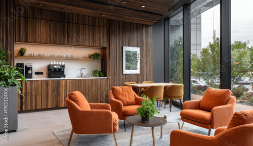 Modern office break room with warm orange armchairs, wooden wall paneling, large glass windows, and minimalist decor creating a cozy and contemporary workspace environment
