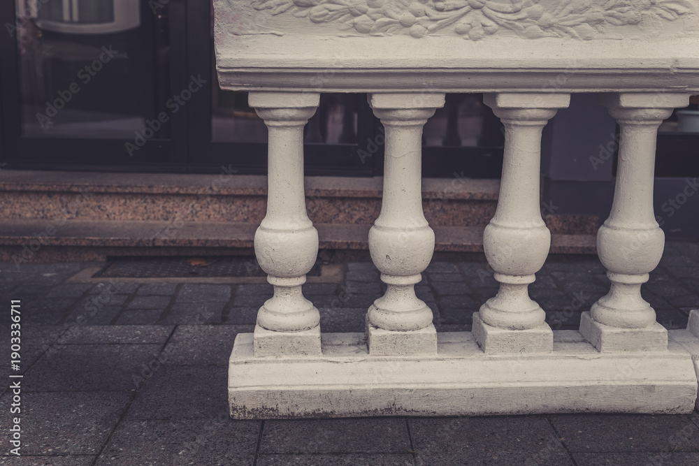 Fototapeta premium Elegant white balustrade supports a charming urban setting in early morning light, showcasing intricate design and craftsmanship