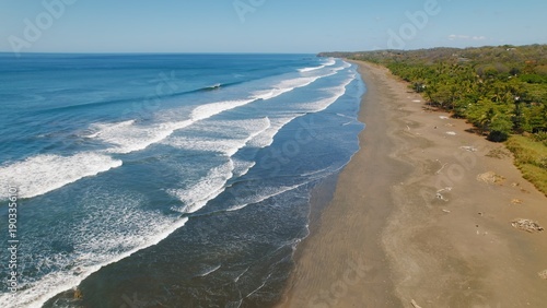 Wallpaper Mural Waves rolling on long sandy shore of Ostional beach on sunny day in Costa Rica. Torontodigital.ca