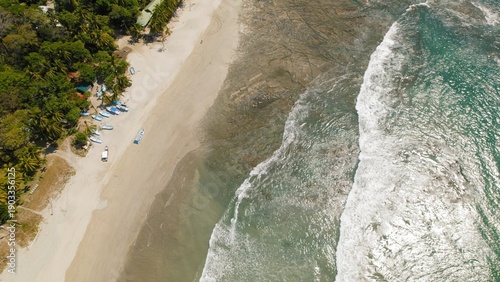 Wallpaper Mural Aerial view of fishing boats along tropical shore with ocean waves on sand beach. Torontodigital.ca