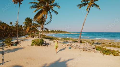 Wallpaper Mural Woman walking on tropical beach path surrounded by palm trees in Yucatan Mexico. Torontodigital.ca
