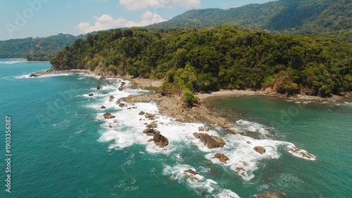 Wallpaper Mural Rocky jungle coast at tropical beach with scenic view of ocean waves in slow motion. Torontodigital.ca
