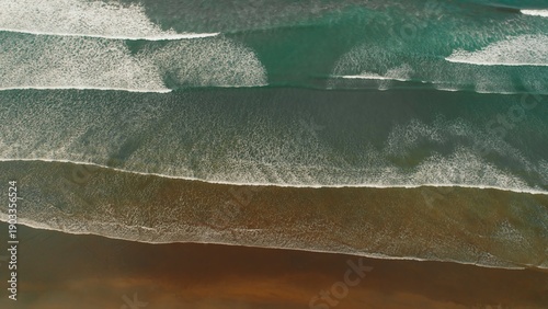 Wallpaper Mural Aerial flight over ocean waves forming rhythmic patterns along vast sandy coastline. Torontodigital.ca