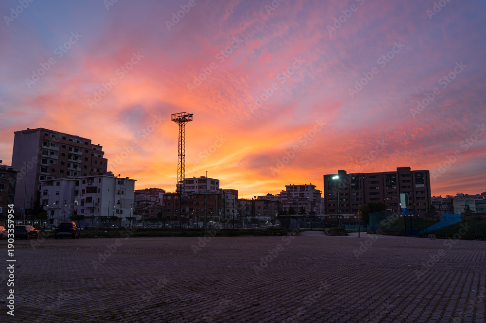 Obraz premium Sunset over Durrës city near the stadium. Urban evening and travel concept. Copy space.