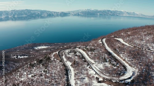 Aerial view of winding road in snowy mountain landscape
