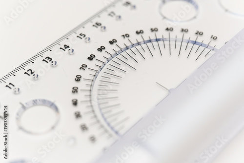 Measuring angles with a transparent protractor on a white surface